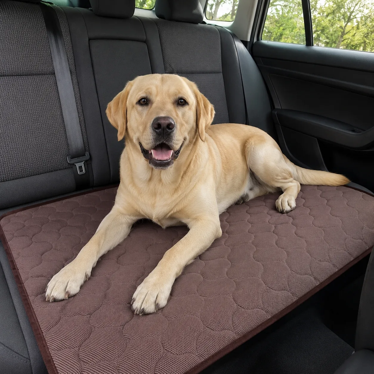 Labrador lying on a brown Frimouf cooling mat on the back seat of a car